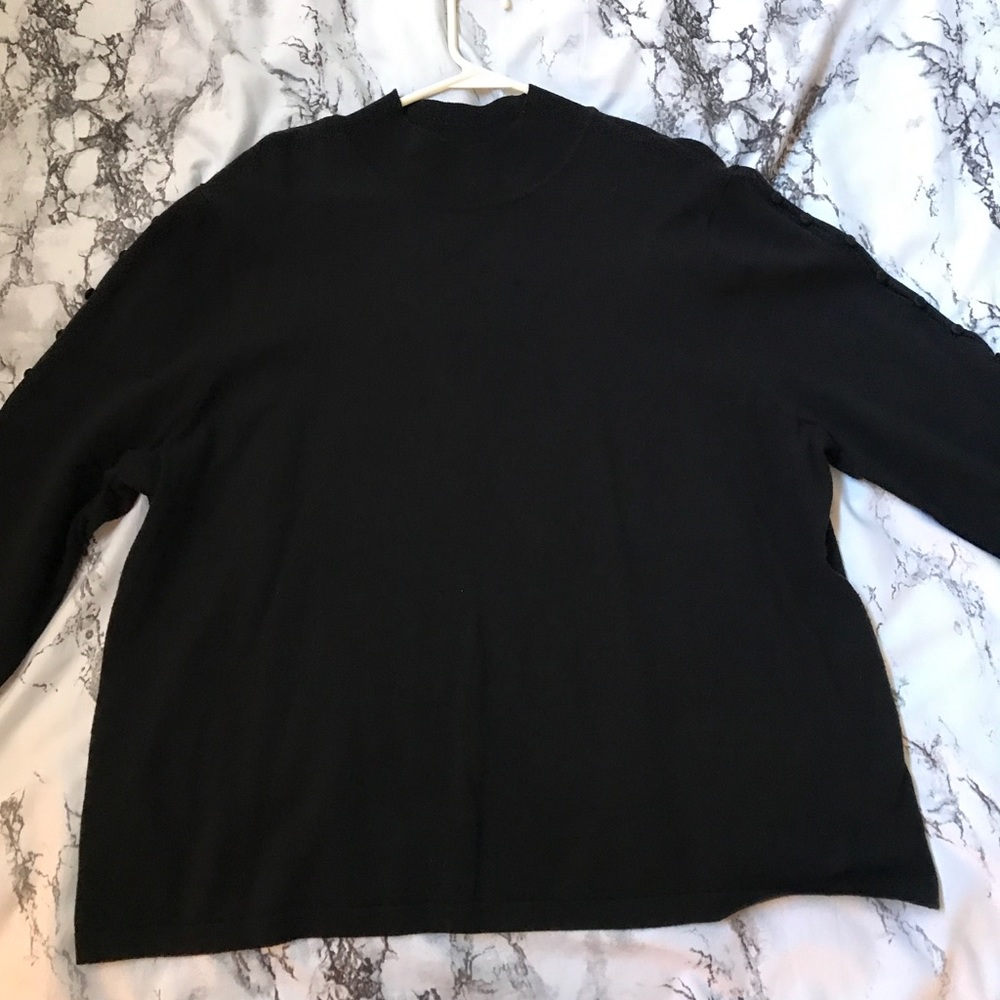 Gently worn black sweater with stylish details.